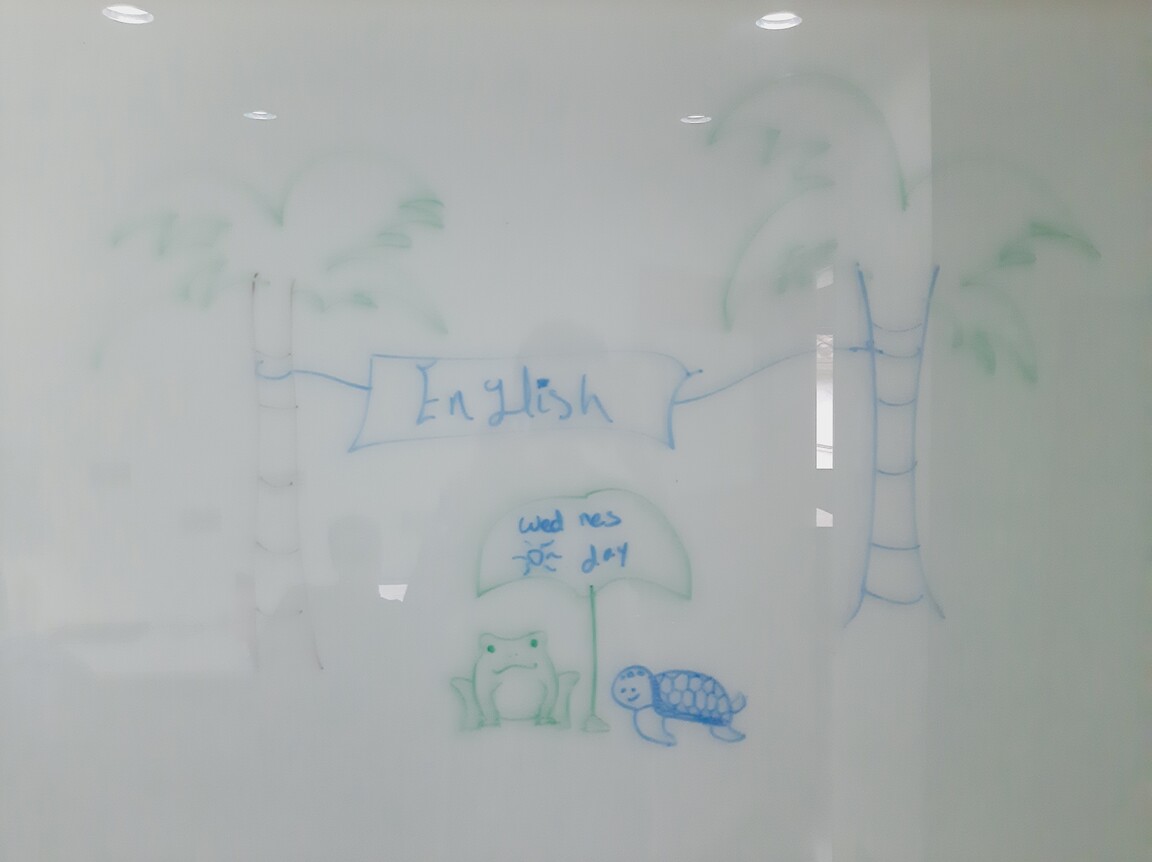 A frog and a turtle underneath an umbrella.